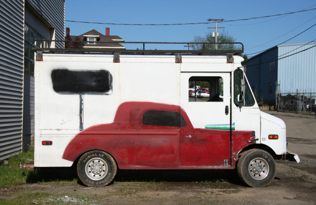 a white van with a red sports car painted on its side