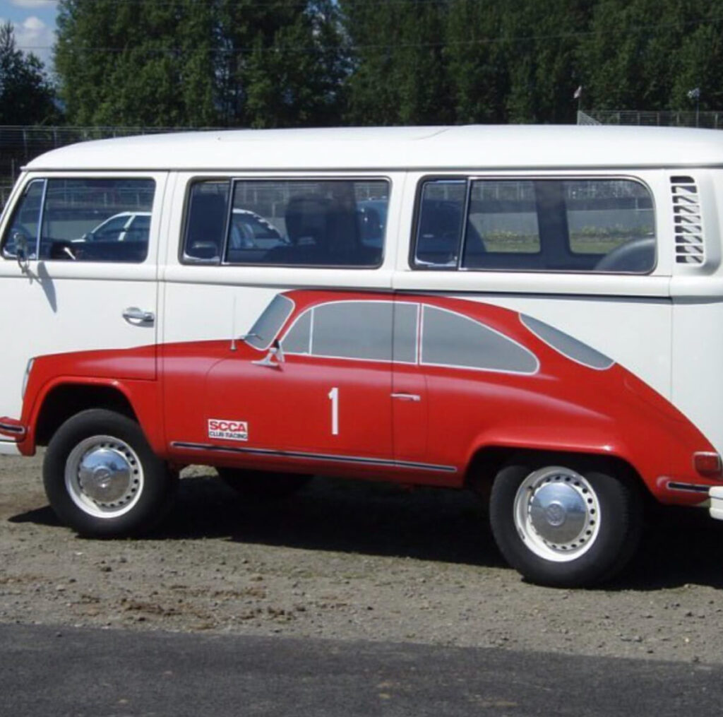 a white van with a red sports car painted on its site